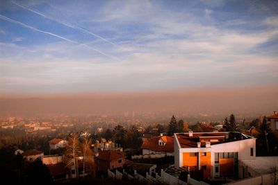 High angle shot of townscape against sky at sunset