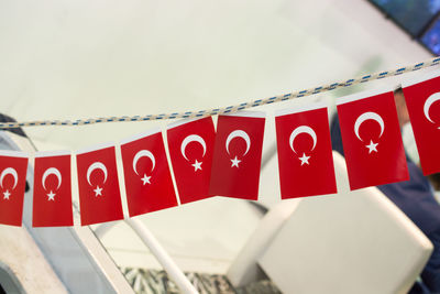 Close-up of flags hanging on rope