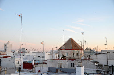 Buildings in city against sky during winter