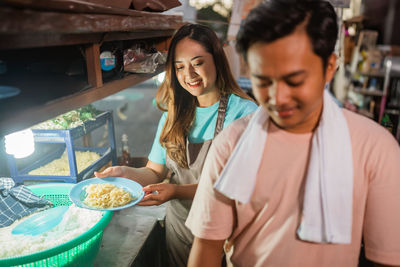 Portrait of young woman preparing food