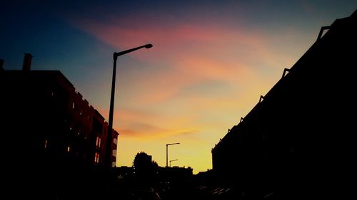 Low angle view of building against sky at sunset