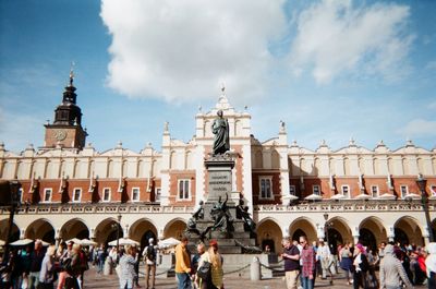 Group of people in historic building against sky