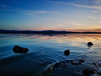 Scenic view of sea against sky at sunset