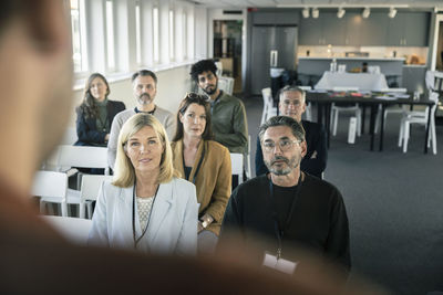 Group of business people attending presentation during conference