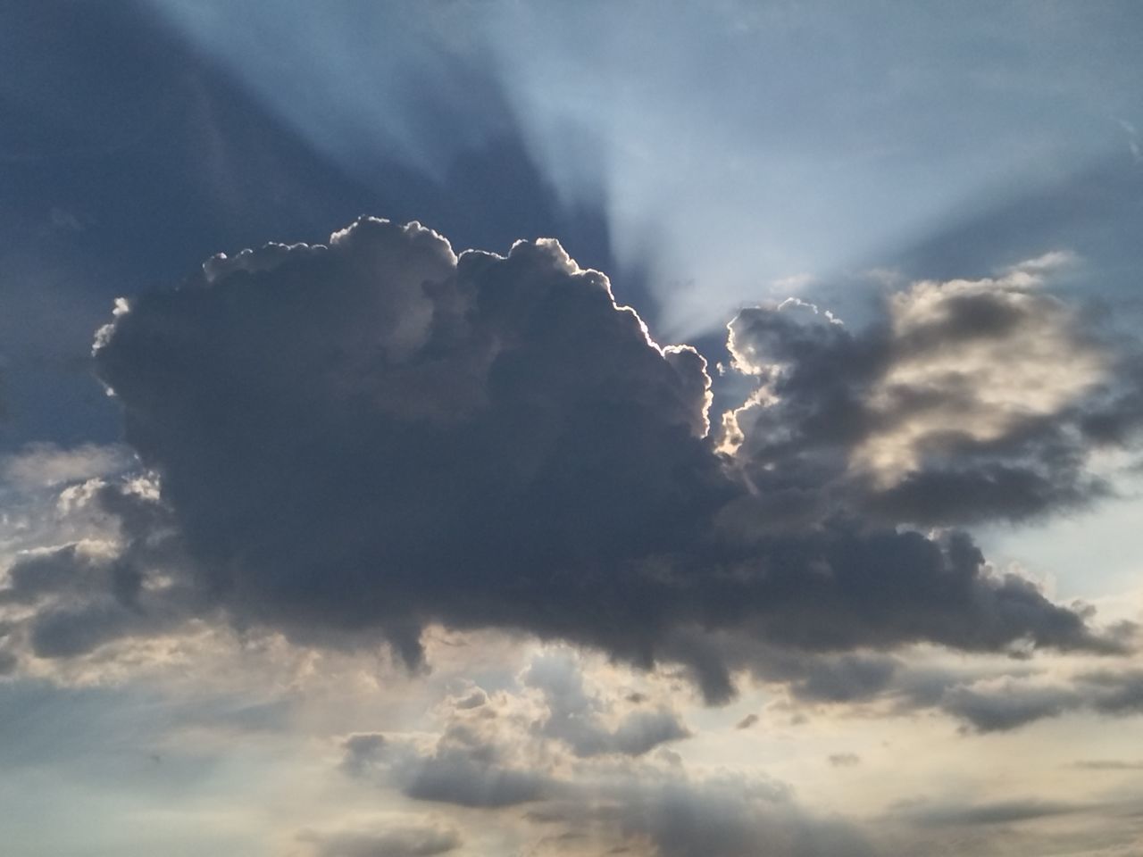 sky, cloud, beauty in nature, nature, storm, environment, thunderstorm, dramatic sky, cloudscape, no people, storm cloud, thunder, sunlight, outdoors, scenics - nature, low angle view, power in nature, day, sunbeam, awe