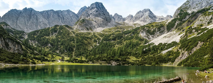 Scenic view of lake and mountains against sky