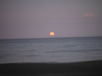 Scenic view of sea against clear sky during sunset