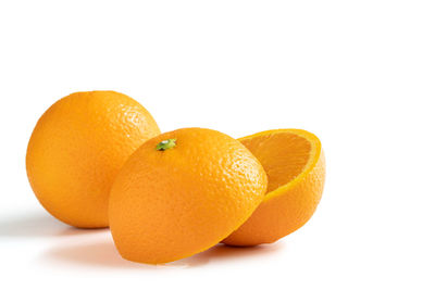 Close-up of orange fruit against white background