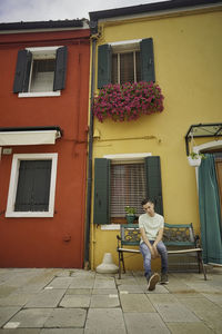 Woman sitting outside building