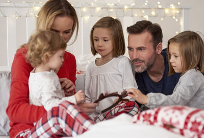 Family on bed at home