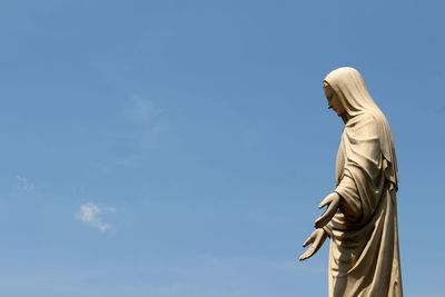 Low angle view of statue against sky