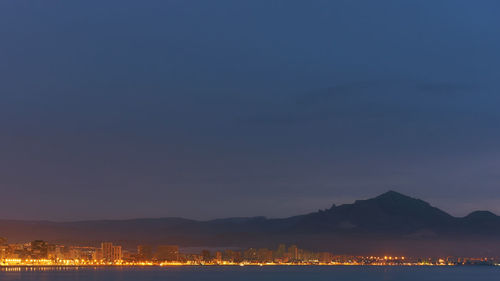 Scenic view of lake against clear sky at night