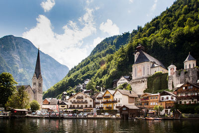 Buildings by lake and mountains