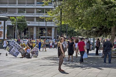 Group of people walking on street in city