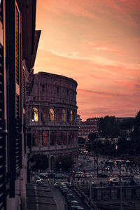 View of the colosseum from the window at sunset. rome, italy.