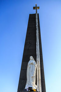 Low angle view of statue against blue sky