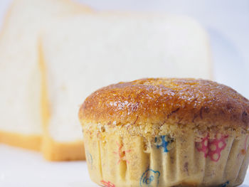 Close-up of cupcake by bread slices on table