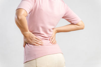 Rear view of woman hand against white background