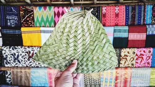 Midsection of person holding multi colored candies for sale