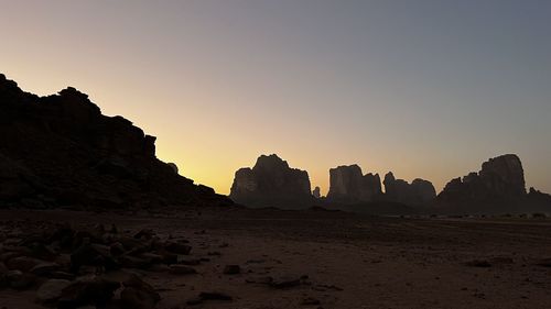 Rock formations against sky during sunset