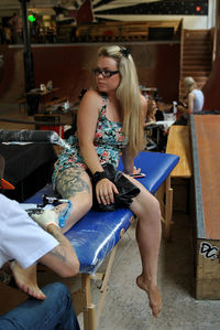 Young woman sitting on sofa