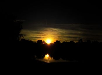 Scenic view of silhouette trees against sky during sunset