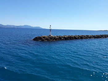 Scenic view of sea against clear blue sky