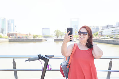 Young woman using mobile phone in city