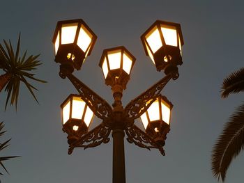 Low angle view of illuminated lamp against sky