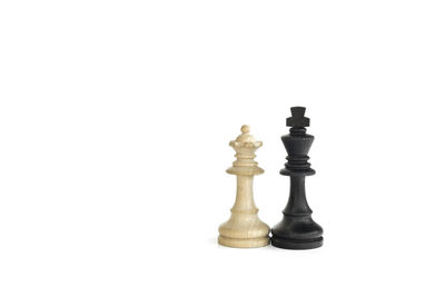 Close-up of chess pieces against white background