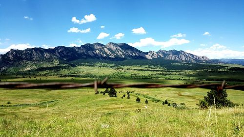 Scenic view of landscape against cloudy sky