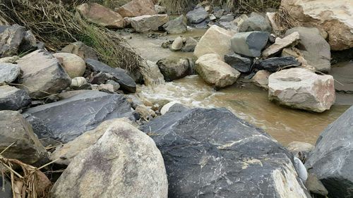 High angle view of stones in stream