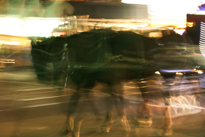 Digital composite image of light trails on street in city at night