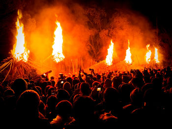 Crowd enjoying music concert at night