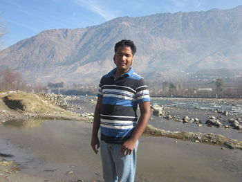 Portrait of young man standing on beach