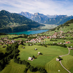 Scenic view of green landscape and mountains against sky