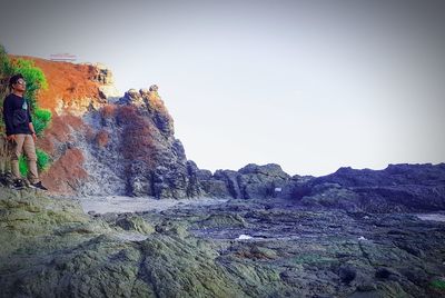 Rock formations on mountain against clear sky