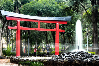 Red and trees by water