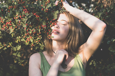 Woman enjoying forest. female portrait in sunset glow at woodland. toned image.