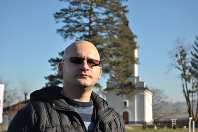 Portrait of man wearing sunglasses while standing outdoors