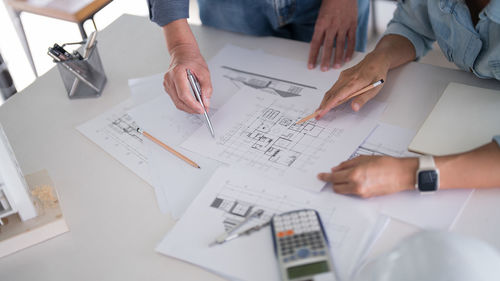 Midsection of businessman working at office