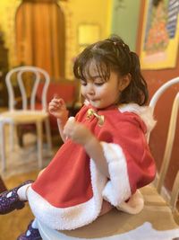 Portrait of girl sitting on table