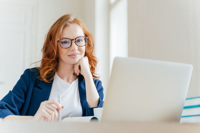 Portrait of businesswoman working at desk in office