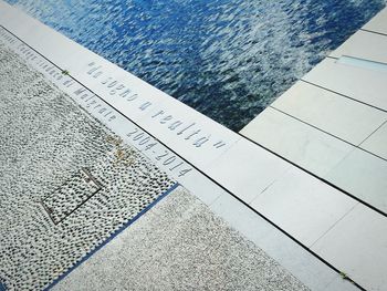 High angle view of text on table by swimming pool