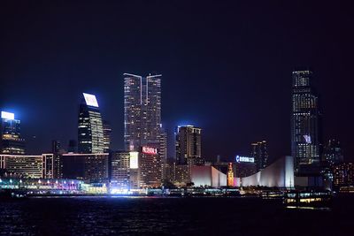 Low angle view of skyscrapers lit up at night