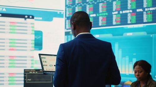 Rear view of man standing in office