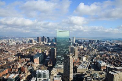 High angle view of cityscape against cloudy sky