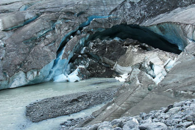 Alpine sofia glacier with large cracks and a river in altai