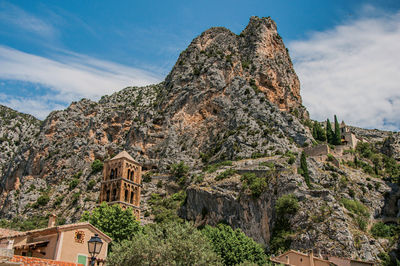 Low angle view of rock formation on mountain against sky