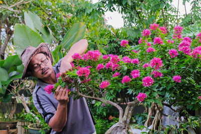 Portrait of man with pink flowers